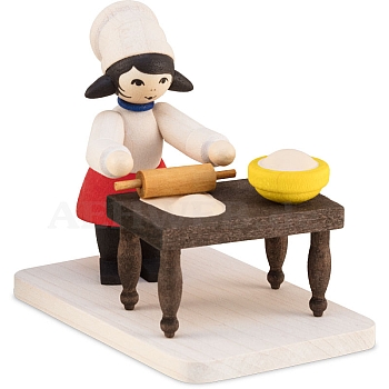 Winter child cookie baker girl with table stained